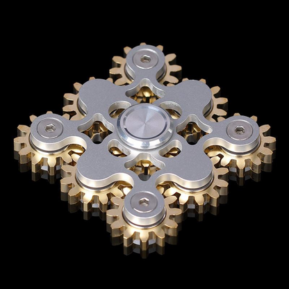 Silver square-layout spinner with multiple exposed gold-tone gears.
