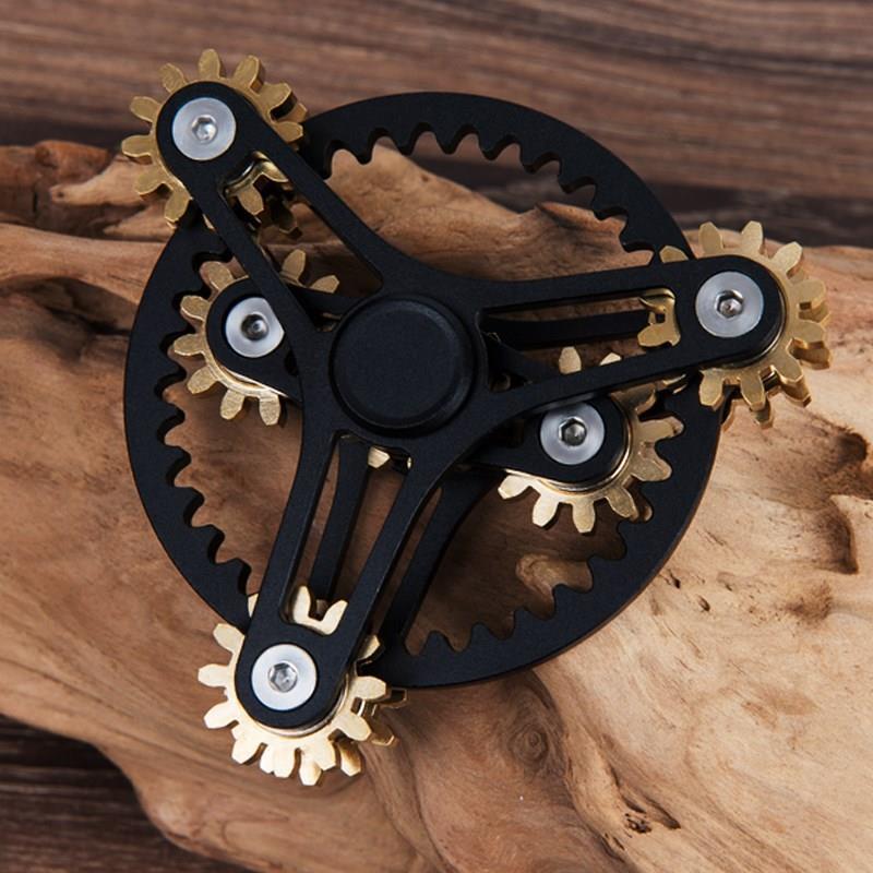Black twin mechanical spinner with three-arm frames, a toothed circular ring and exposed gears.