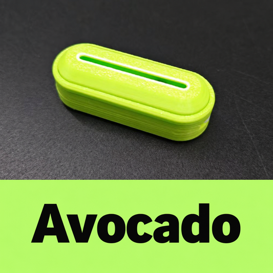 Avocado-colored Smooth fidget slider with rounded ends, a textured face and a narrow elongated window; its Chinese color label appears below.