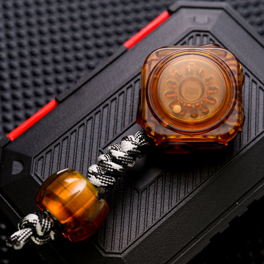 Amber Fidget Master with a numbered roulette, braided cord and grooved Sonic PEI bead.