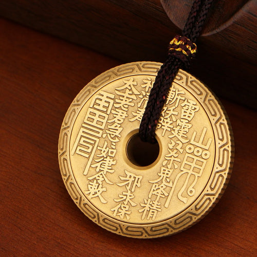P2 brass ratchet coin with raised Chinese lettering, a patterned rim and a pendant cord through its center.