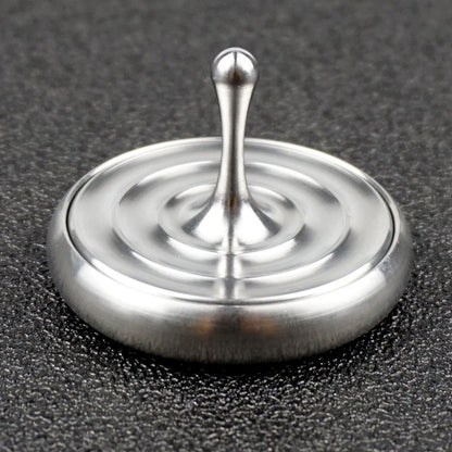 Water-drop spinning top and matching base in an angled view