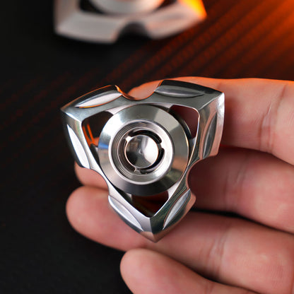 Single silver-tone Siren spinner held between the fingers