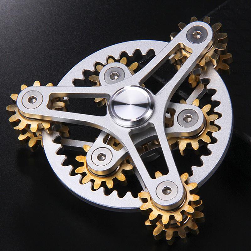 Silver-tone open-frame gear-linked spinner on a dark background