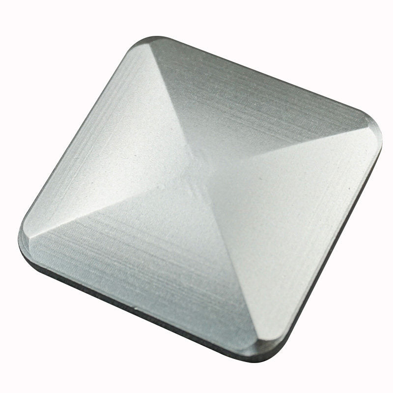 Silver-tone faceted desktop flip toy on a white background