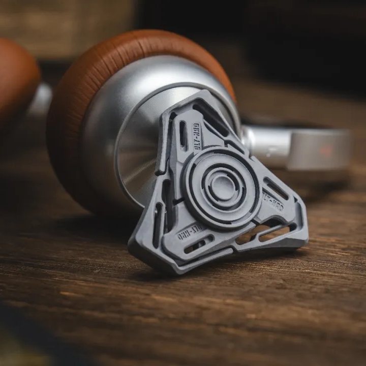 The titanium-alloy Hades spinner resting on a wooden surface